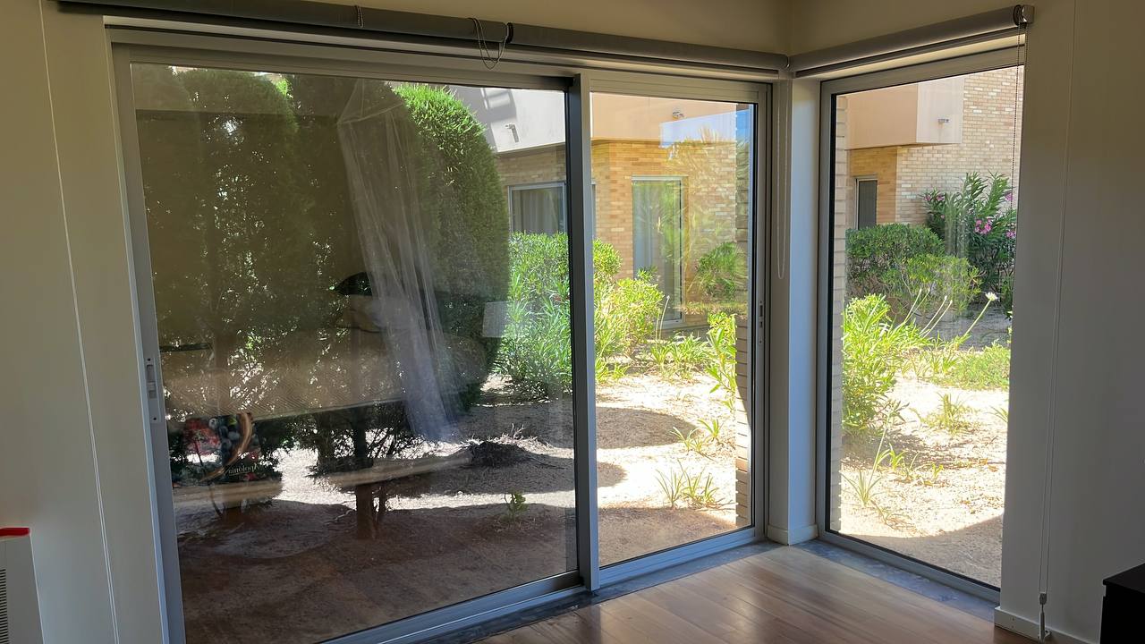 Mosquito screen installed on large sliding glass doors, interior view, Algarve