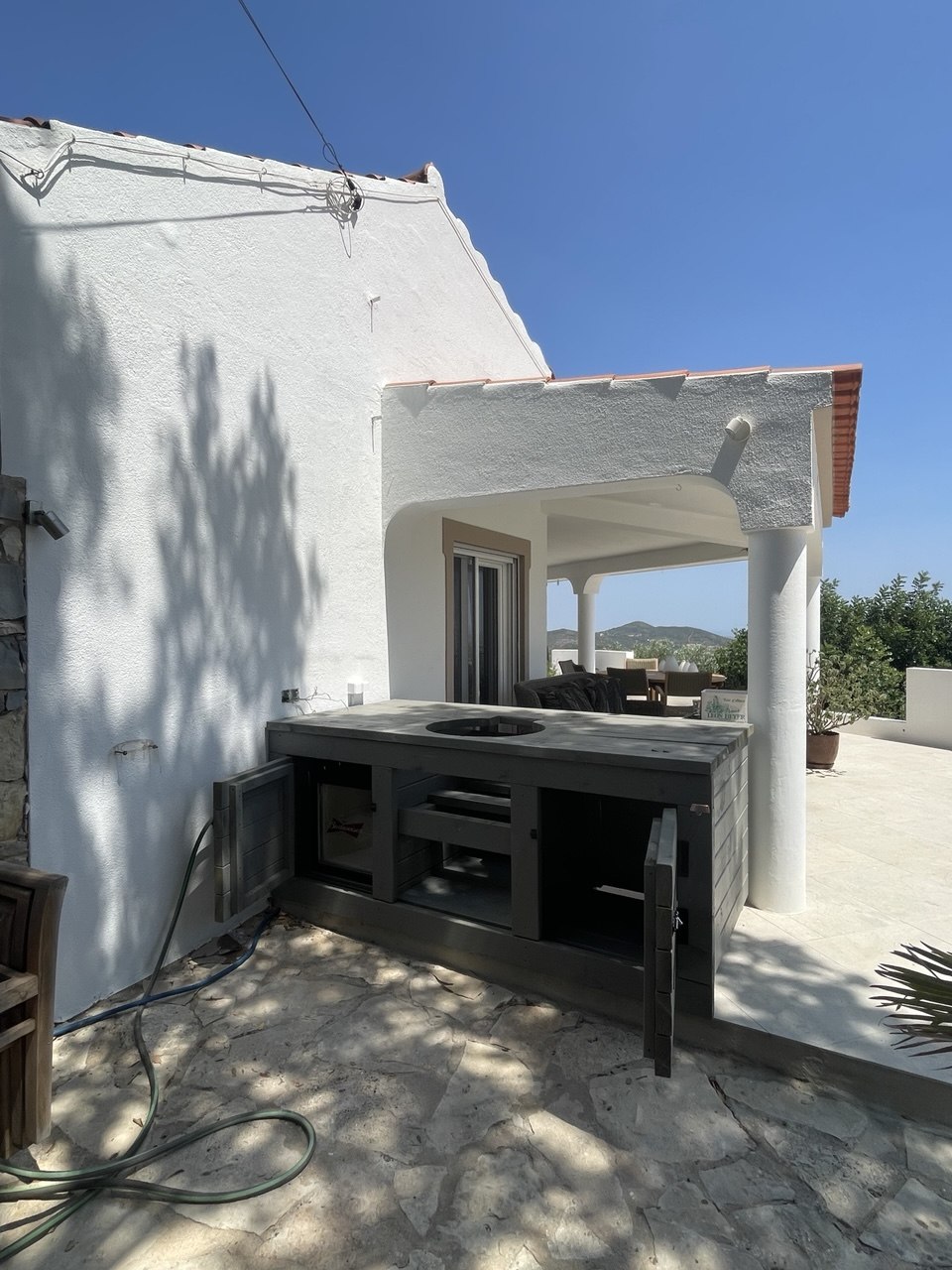 Outdoor kitchen counter with open storage cabinets, Algarve terrace