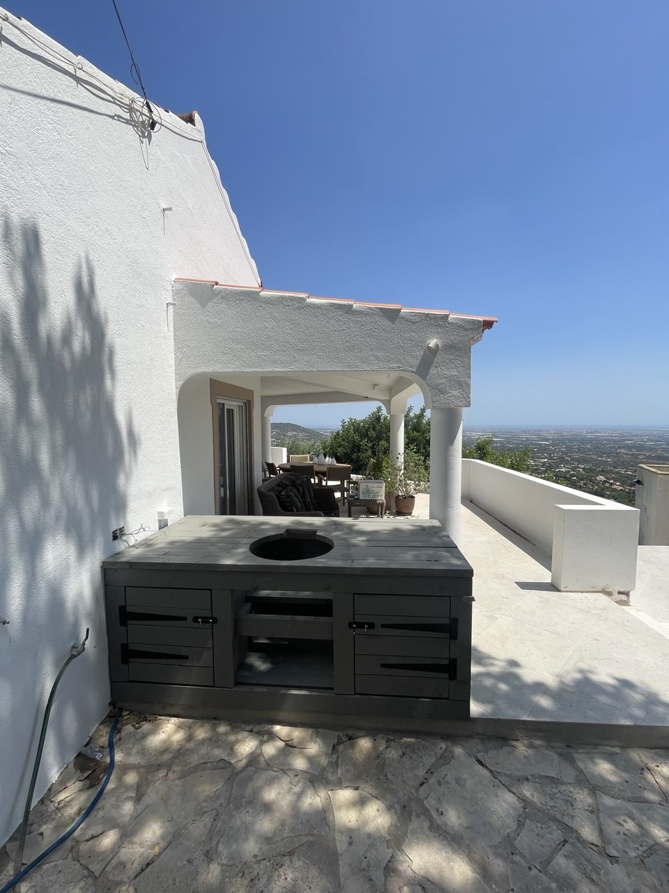Outdoor kitchen counter with built-in grill installed on villa terrace, Algarve