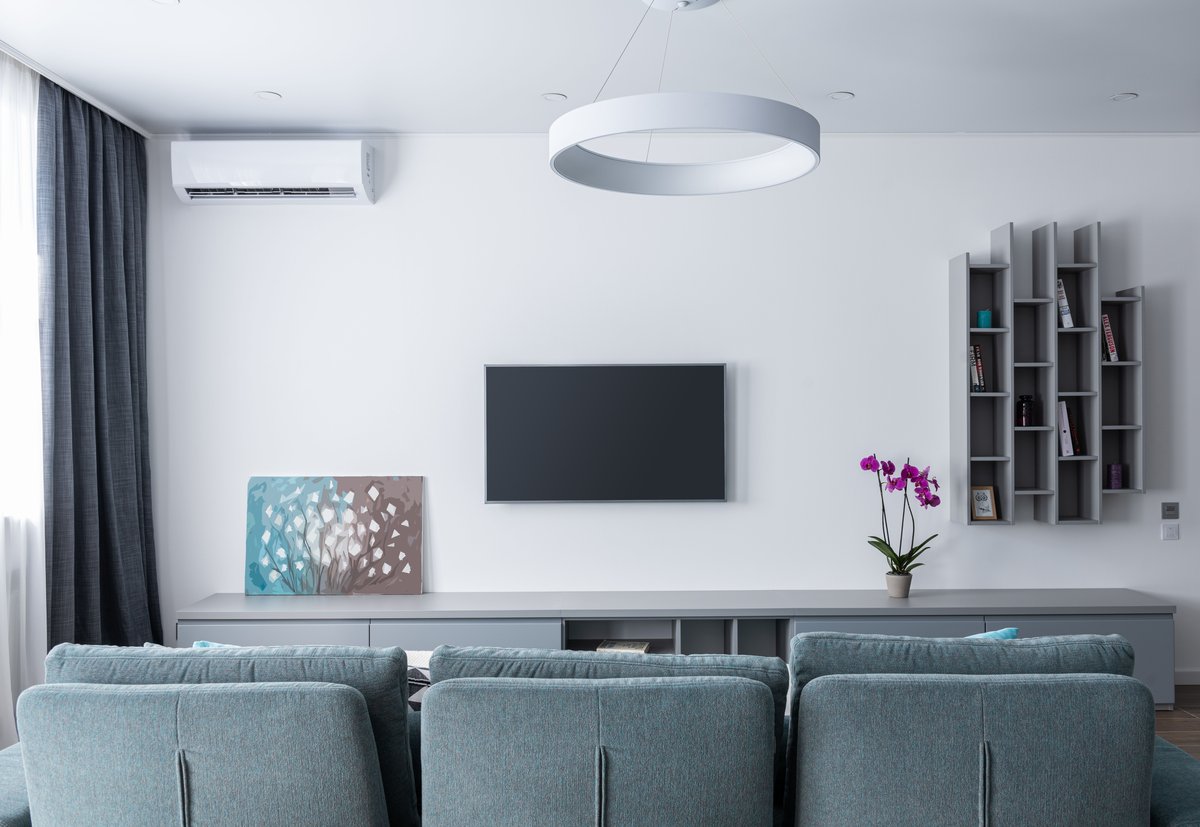 Wall-mounted flat-screen TV with AC unit in modern living room, Algarve